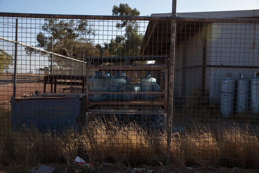 Water containers inside a cage in the remote WA Aboriginal community of Blackstone.