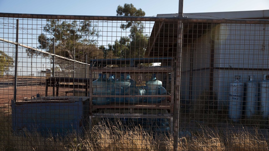 Water containers inside a cage in the remote WA Aboriginal community of Blackstone.