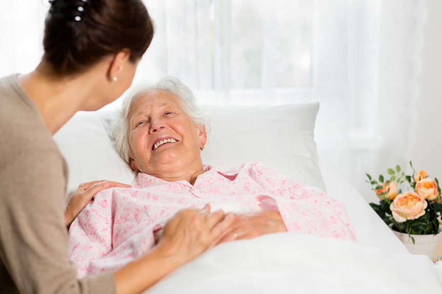 Lady in bed smiling