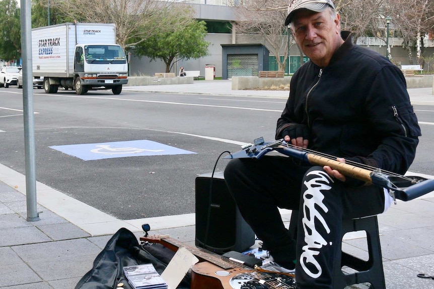 Steve Wakeling plays bluegrass music outside Northgate Shopping Centre.