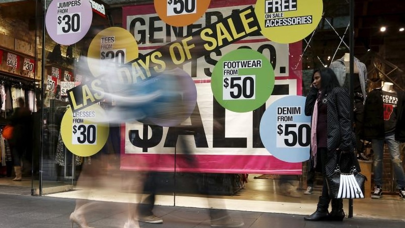 An image of a shop window advertising discounted clothes in Sydney