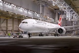 Qantas's first Dreamliner 787-9 sits in a factory.