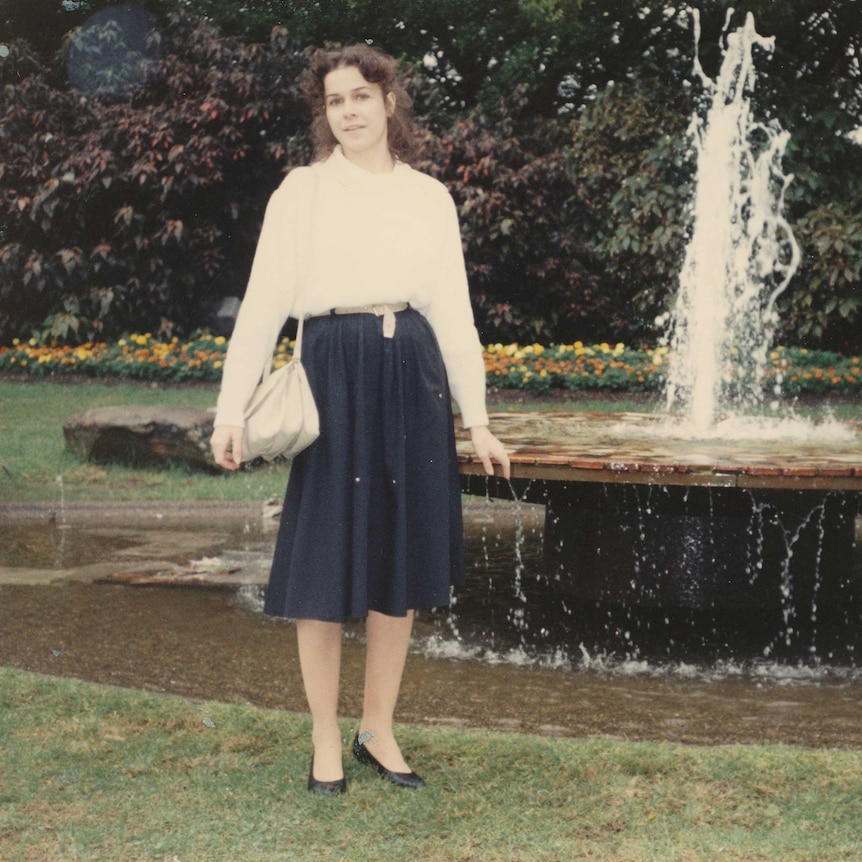 An old image of Anne-Marie Culleton standing in front of a fountain.
