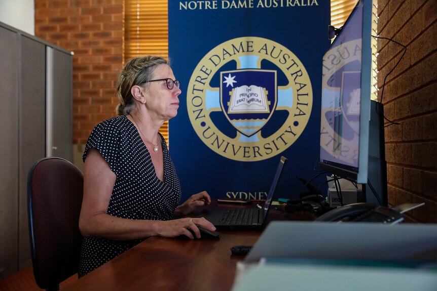 Professor Lisa Wood from Notre Dame University sitting at her office desk.
