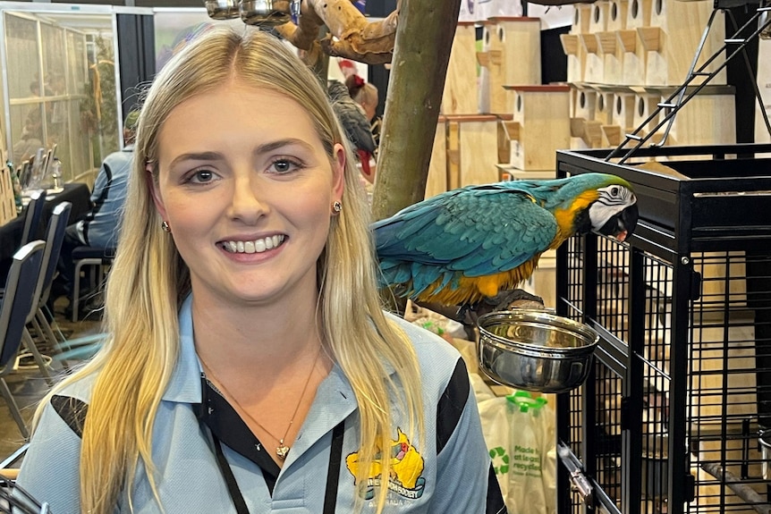 Woman with blue and yellow macaw.