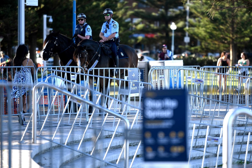 Mounted police are seen patrolling a closed Coogee Beach.