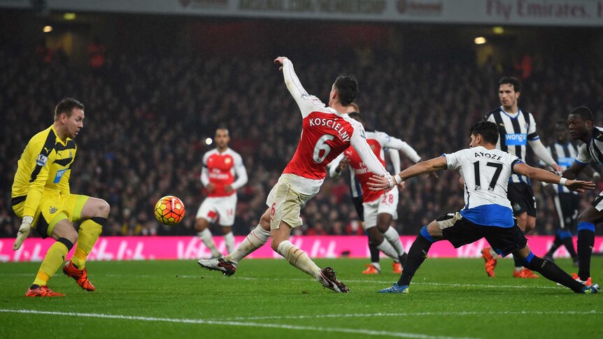 Arsenal's Laurent Koscielny scores past Newcastle United's Rob Elliot in the Premier League.