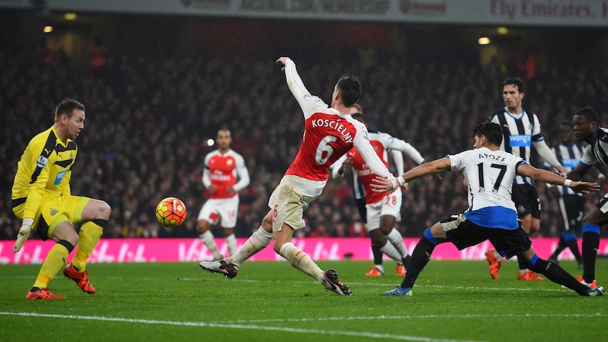 Arsenal's Laurent Koscielny scores past Newcastle United's Rob Elliot in the Premier League.