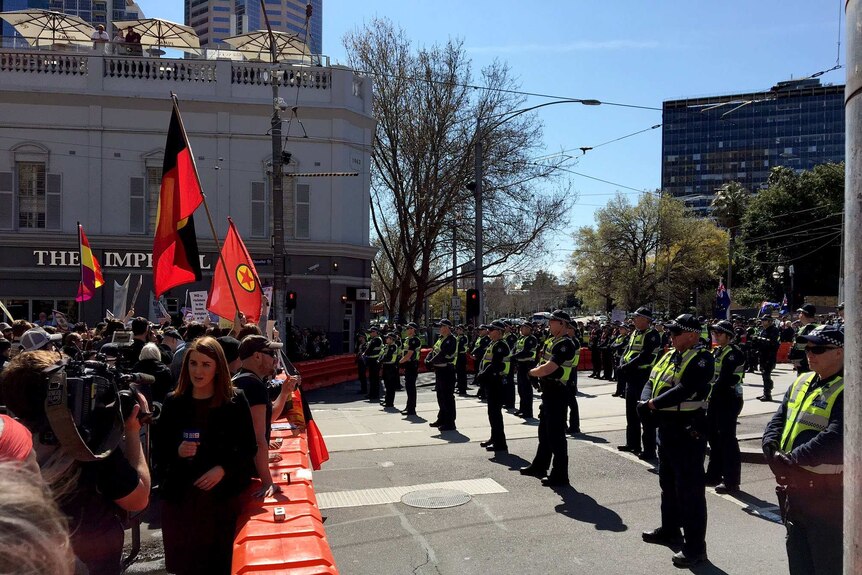 Rival protest groups outside Victoria's Parliament are separated by police.