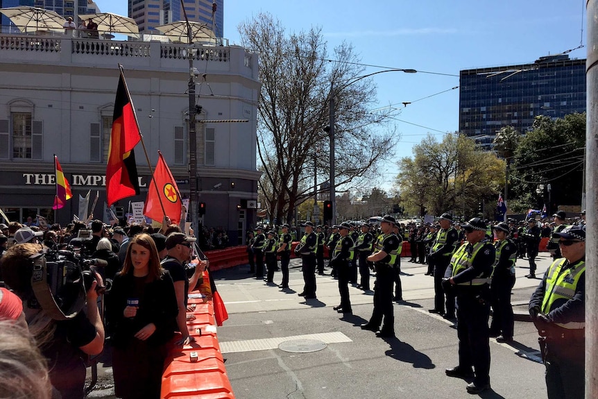 Rival protest groups outside Victoria's Parliament are separated by police.