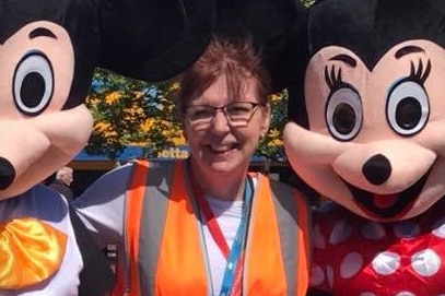 Rhonda O'Sign with two Disney mascots.