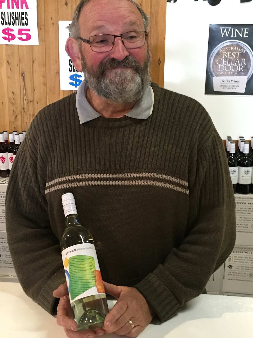 Winemaker Chris Pfeiffer with a newly bottled 2015 pinot grigio.