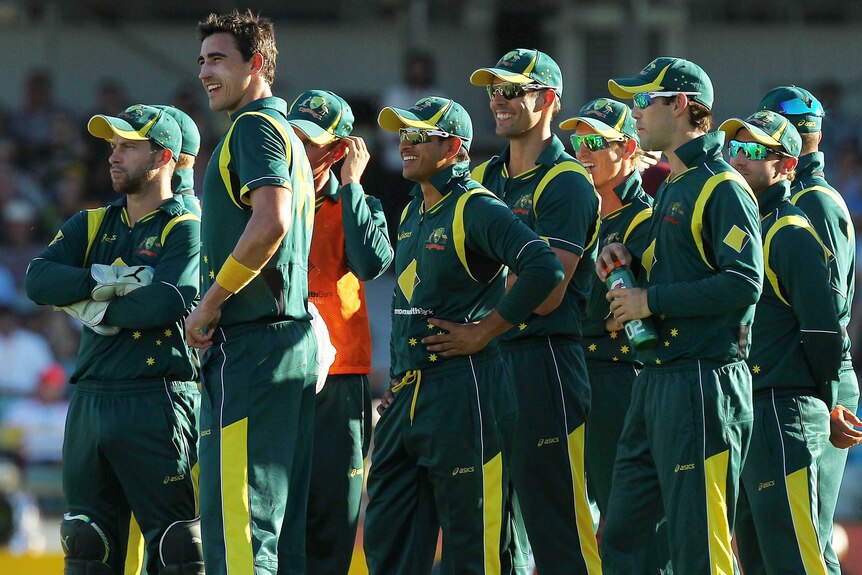 Australian players watch the big screen, waiting for a decision on a challenge against the wicket of Devon Thomas.