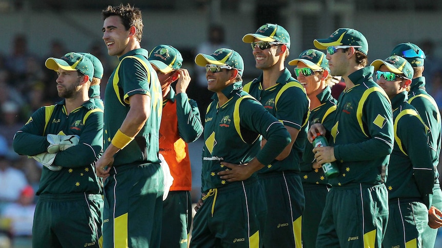 Australian players watch the big screen, waiting for a decision on a challenge against the wicket of Devon Thomas.