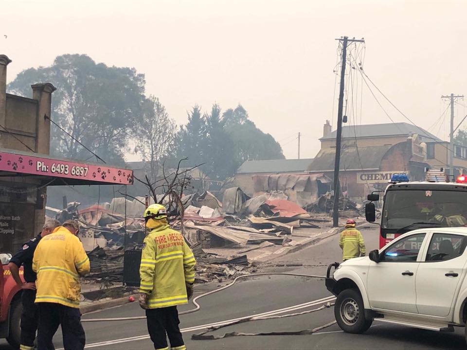 firefighters observing the destroyed remains