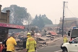 firefighters observing the destroyed remains