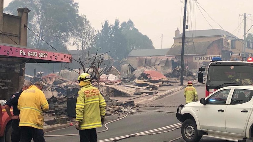 firefighters observing the destroyed remains