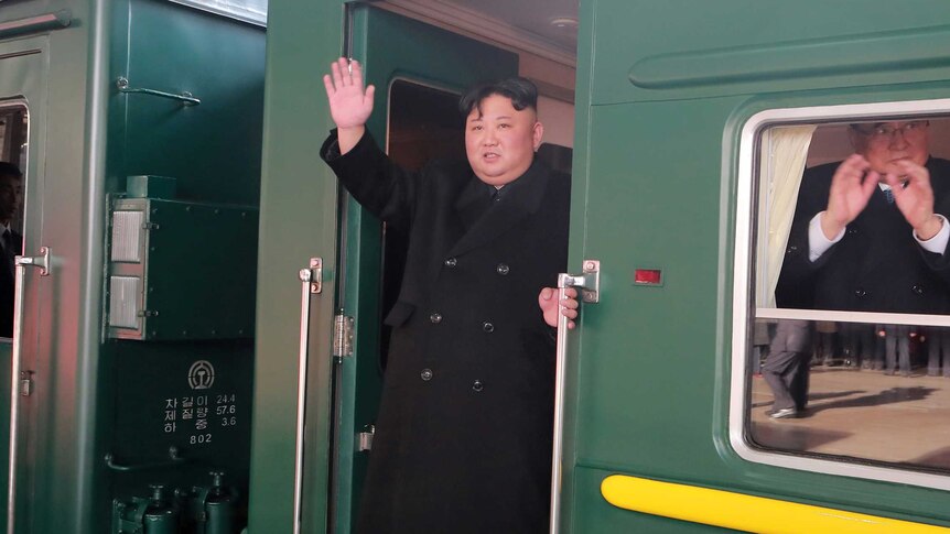 Kim Jong-un waves from a train