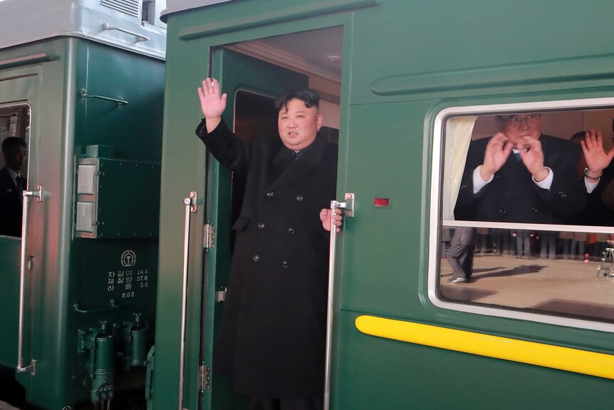 Kim Jong-un waves from a train