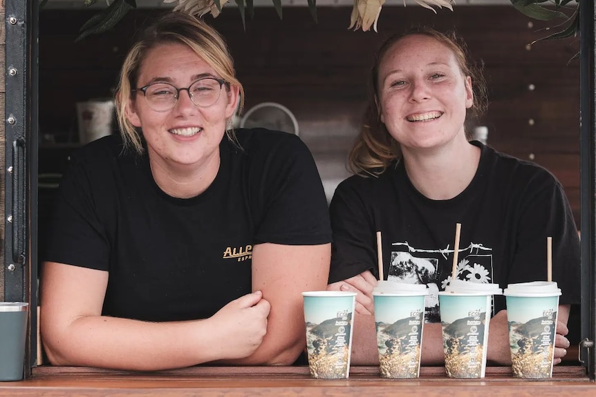 Two ladies in coffee van smiling at camera