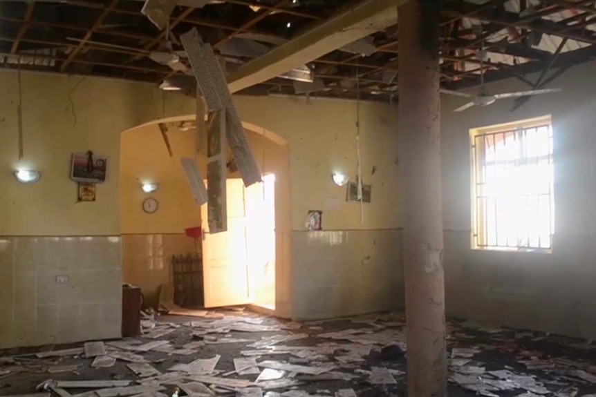 A still image from a video shows damage and debris inside a mosque.