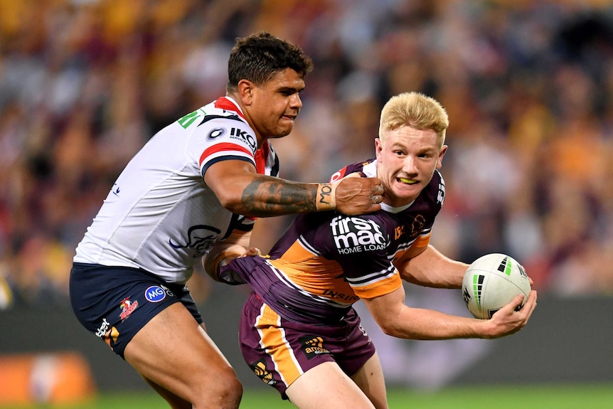Tom Dearden is scragged by Latrell Mitchell