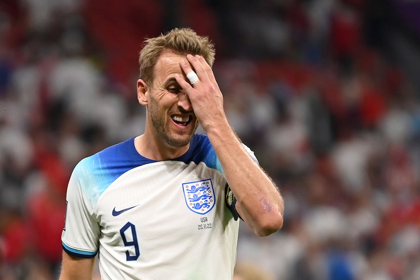 Harry Kane holds his head and grimaces