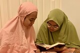 Shereena and Emilee Kai reading the Quaran