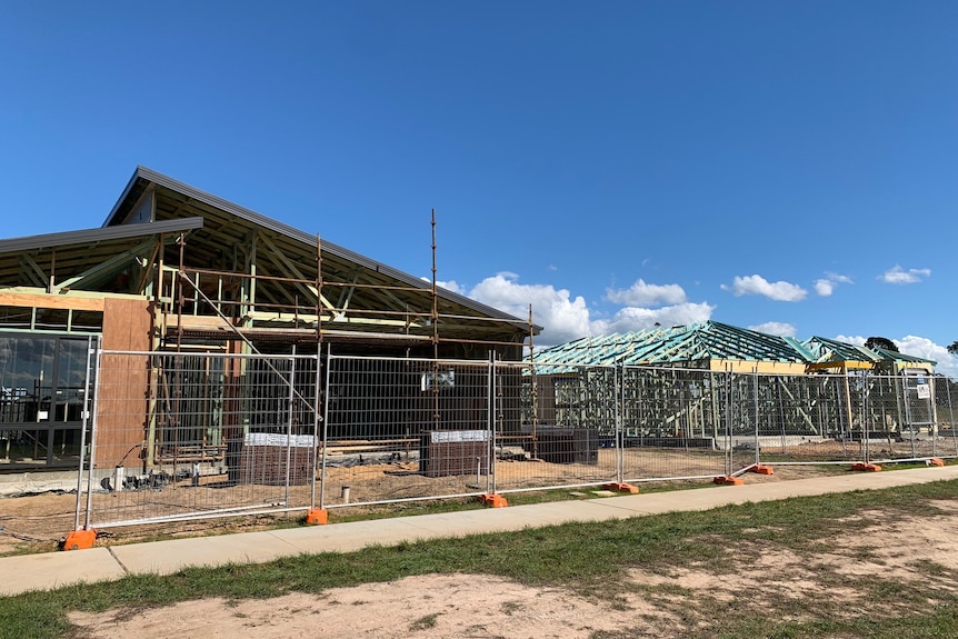 Street view of wooden frames of new homes being built in a housing estate