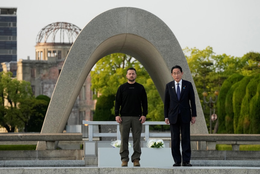 Volodymyr Zelenskiy and Fumio Kishida stand at a park