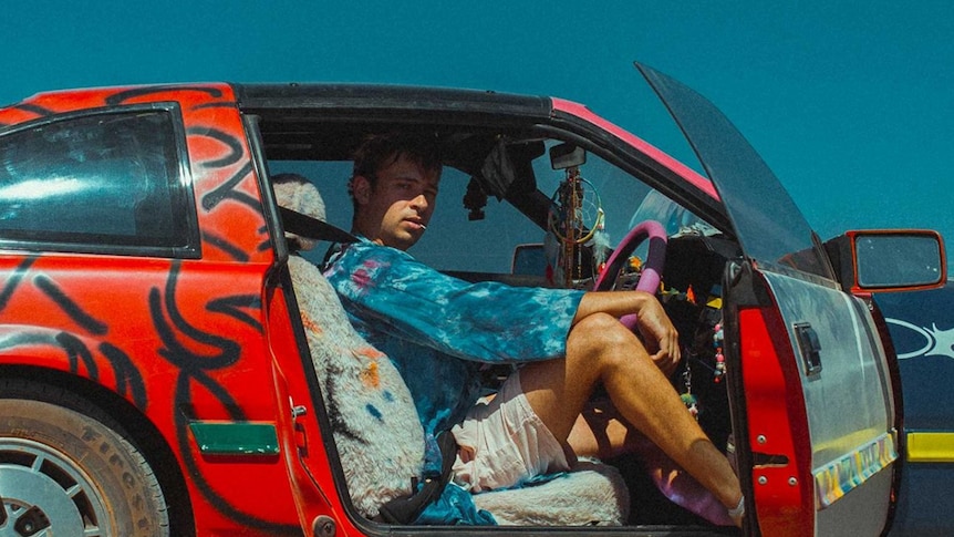 A 2019 press shot of Flume sitting in the car from the Hi This Is Flume mixtape