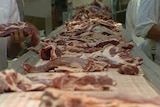 Pieces of meat on an assembly line
