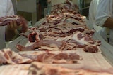 Pieces of meat on an assembly line.