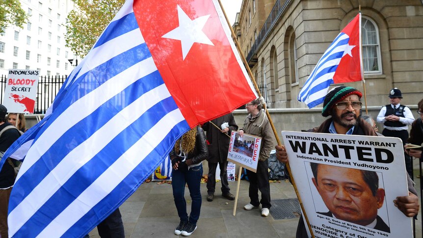 Wide shot of people holding West Papua flags.