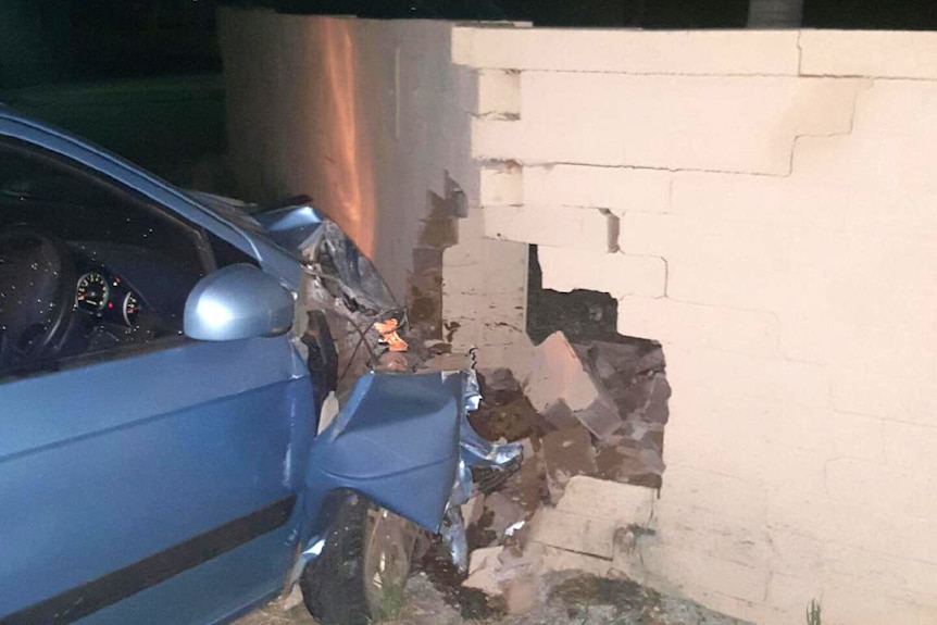 A blue car crashed into a wall after it was allegedly driven by a child.