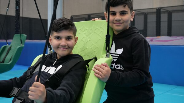Two kids with a chair swing