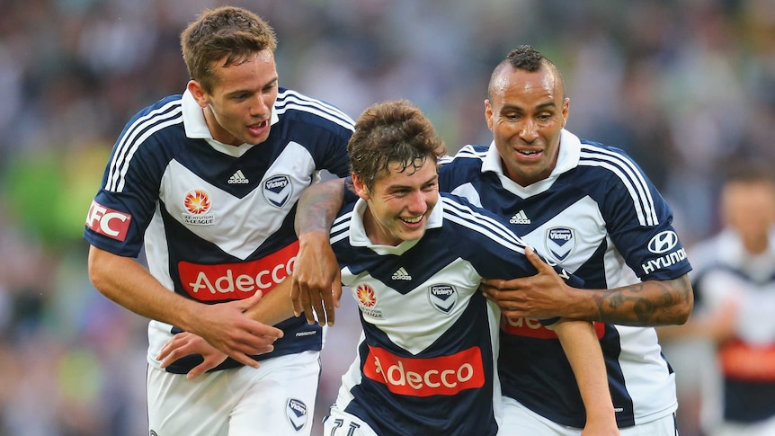 Marco Rojas (centre) celebrates after he scored the first goal with Archie Thompson during Friday night's match.