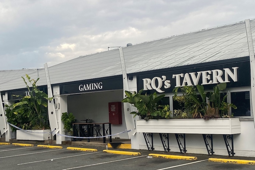 A police van is parked outside a gaming tavern