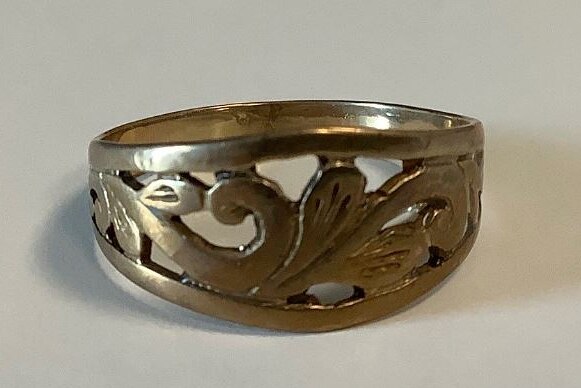 A gold ring with intricate engraving.