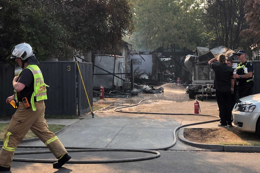 Police and fire officials at the scene of a property damaged by a fire at Seaford.