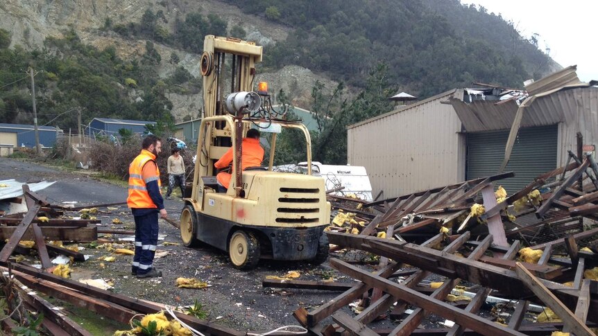 A forklift helps with cleanup efforts in Round Hill, Tasmania after severe winds battered the area.