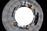 A 360-degree shot of the far side of the moon shows the grey moonscape, the lander and the rover.