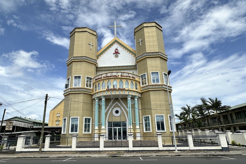 The facade of Samoa Independent Seventh Day Adventist Church, which has colours of gold and light blue.