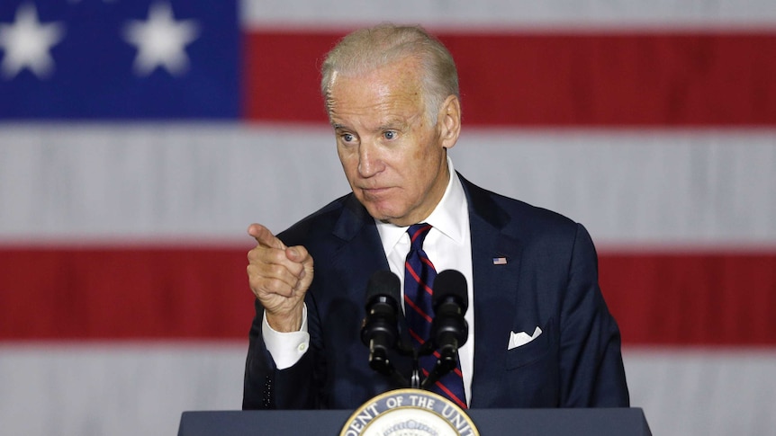 US Vice President Joe Biden stands at a podium while speaking at a campaign rally.