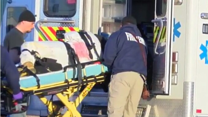 Emergency services workers load a patient into an ambulance after a shooting at a Kansas lawnmower factory