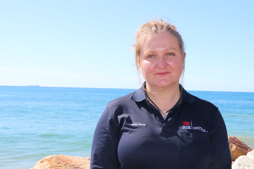 Nicole Strehling is standing on the foreshore, wearing a navy shirt. She has fair hair.