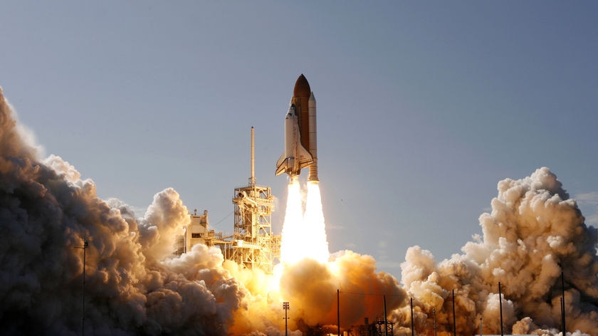 The space shuttle Discovery lifts off