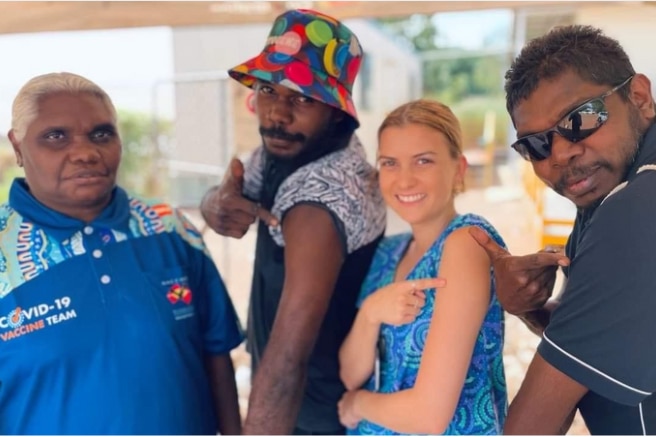 Sally Maymuru stands with three colleagues in Yirrkala. 