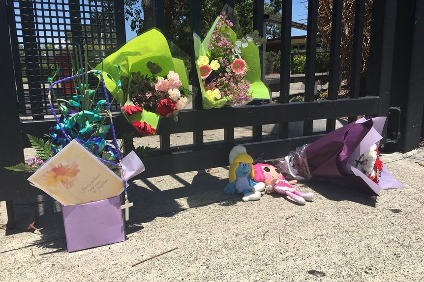 Flowers and toys left at the gates of the Marsden school where 12-year-old Tiahleigh Palmer was a student