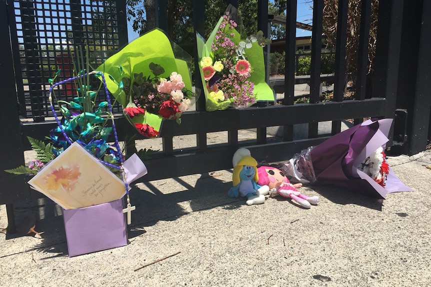 Flowers and toys left at the gates of the Marsden school where 12-year-old Tiahleigh Palmer was a student
